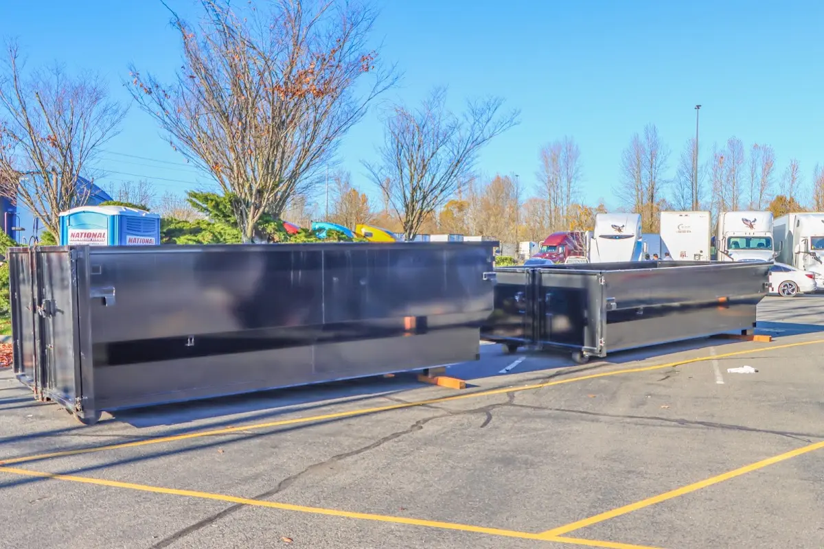 Professional dumpster rental service with roll-off container on residential driveway in Five Corners